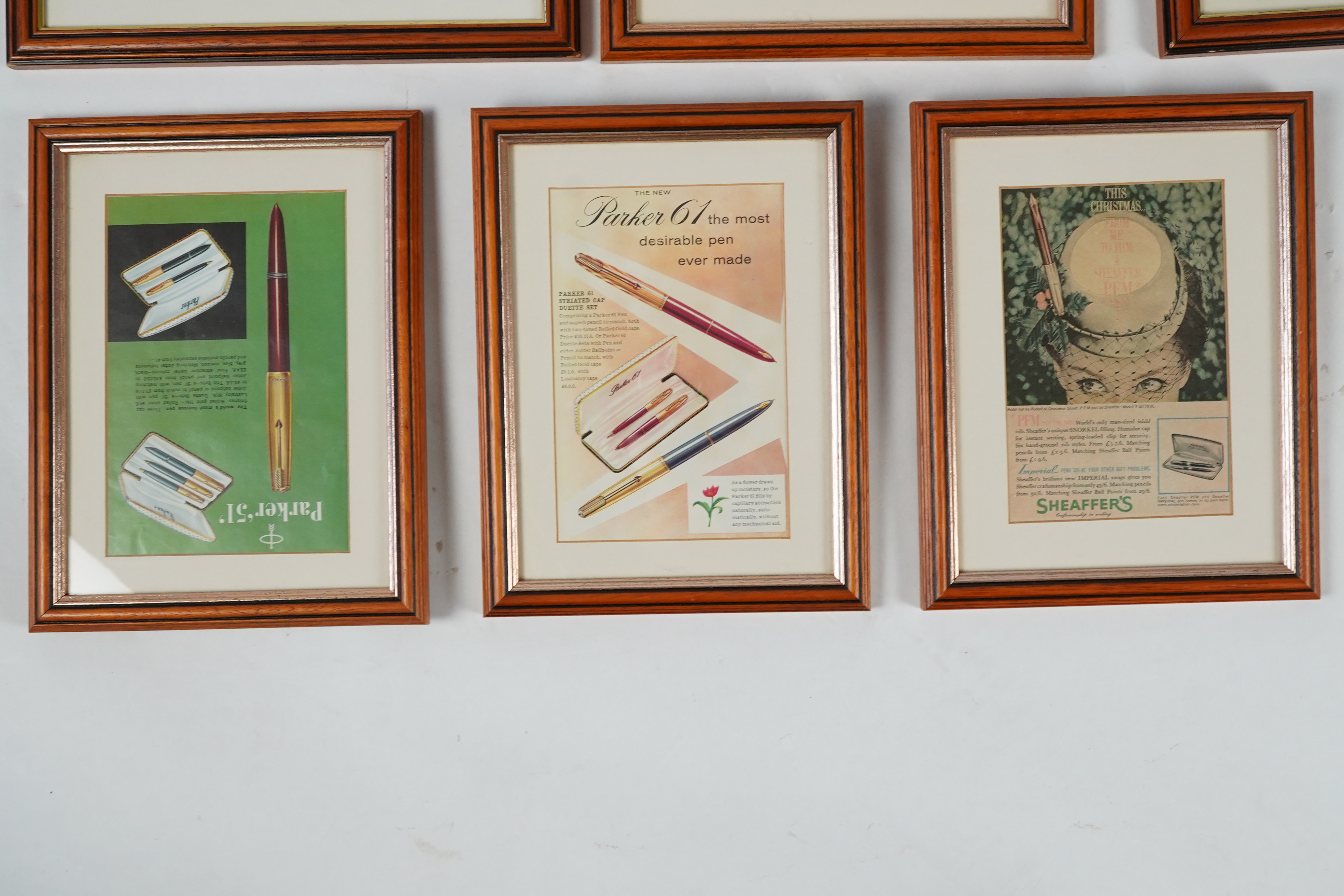 Framed fountain pen adverts (12)